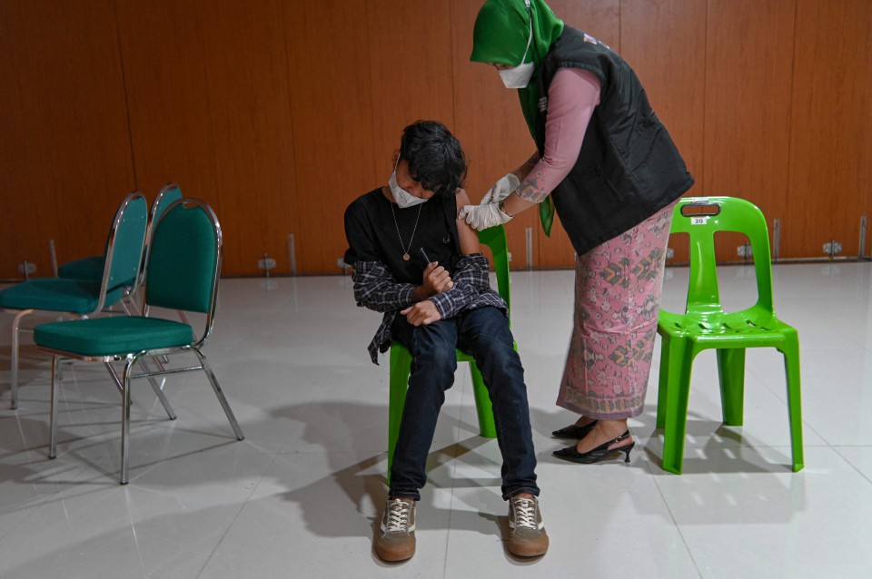 Remaja lelaki menerima dos Sinovac di Banda Aceh, Indonesia. - Foto AFP